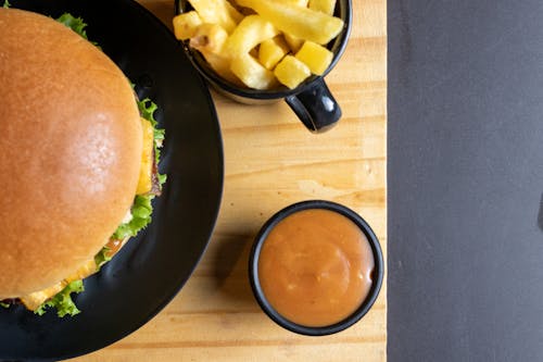 Free Hamburger and French Fries on Wooden Table Top Stock Photo