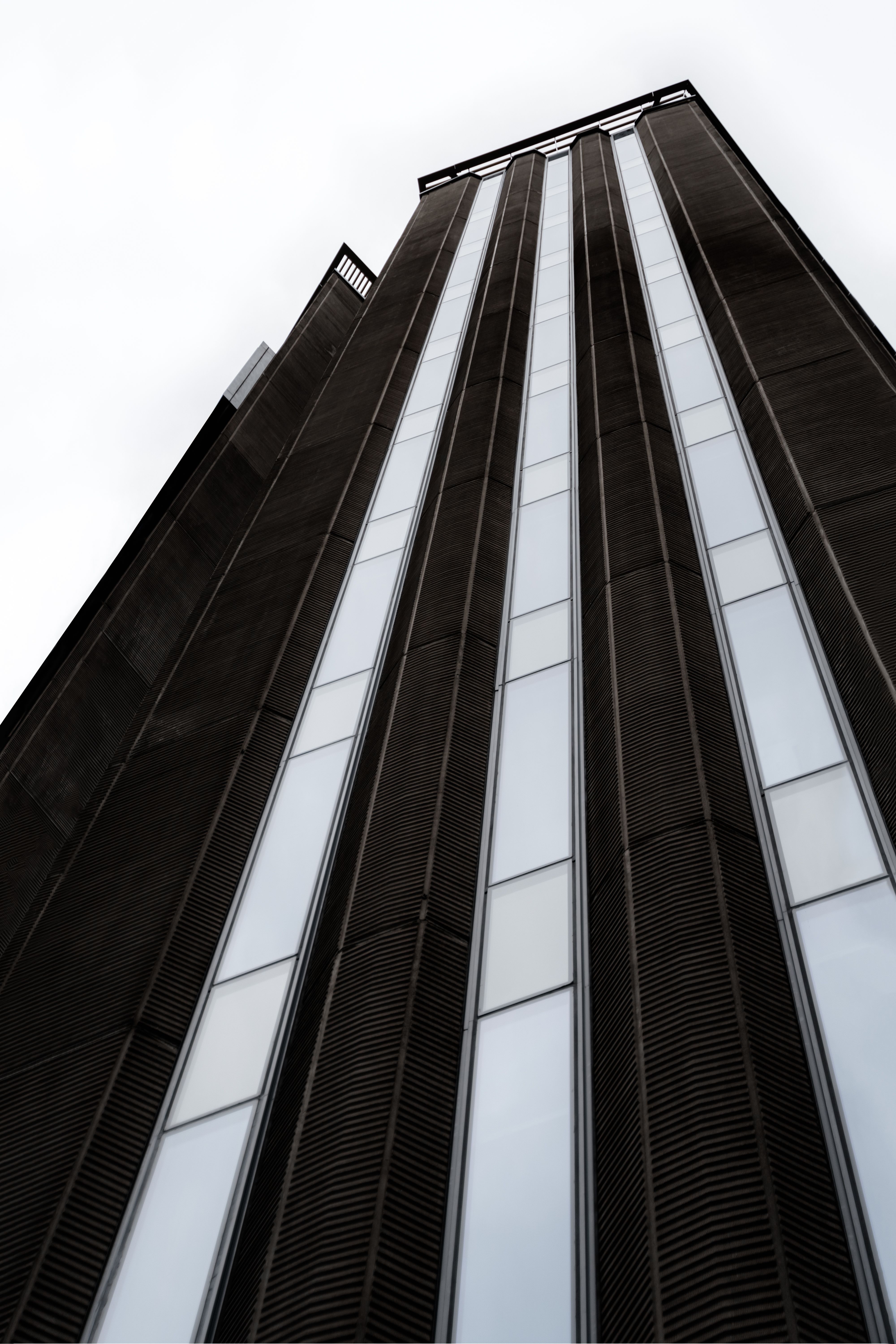 Low Angle Shot of a High Rise Building Under White Sky · Free Stock Photo