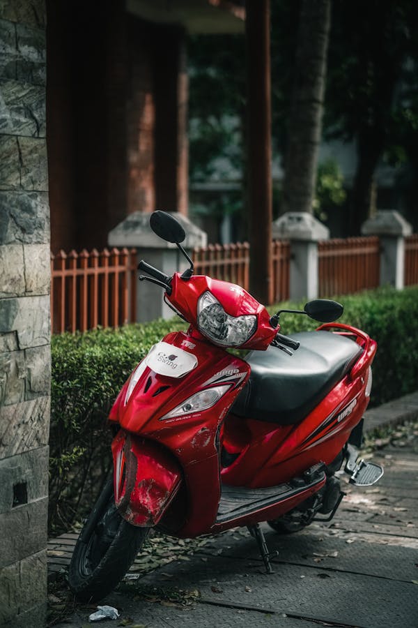 A Red Motorcycle Parked on a Sidewalk