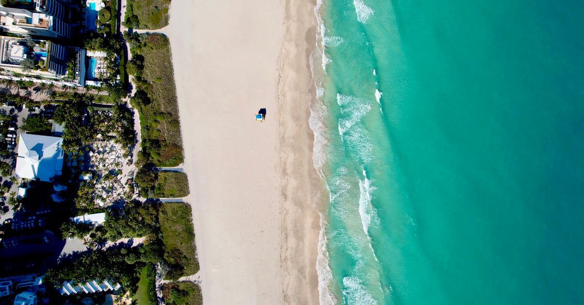 Stunning aerial view of Miami Beach's coastline, showcasing turquoise waters and sandy shorelines.