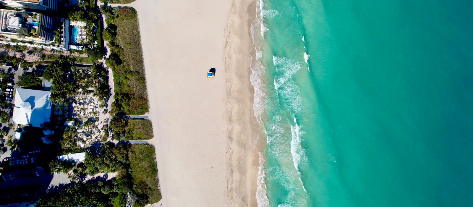 Stunning aerial view of Miami Beach's coastline, showcasing turquoise waters and sandy shorelines.