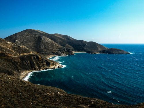 Free Stunning aerial photograph of the Peloponnesian coastline in Greece, showcasing vibrant blue waters and rugged cliffs. Stock Photo