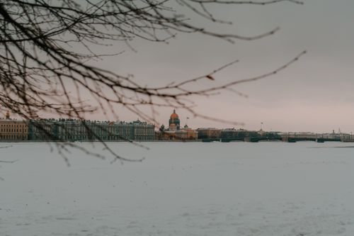 Free Scenic winter view of Saint Petersburg skyline and frozen river covered in snow. Stock Photo
