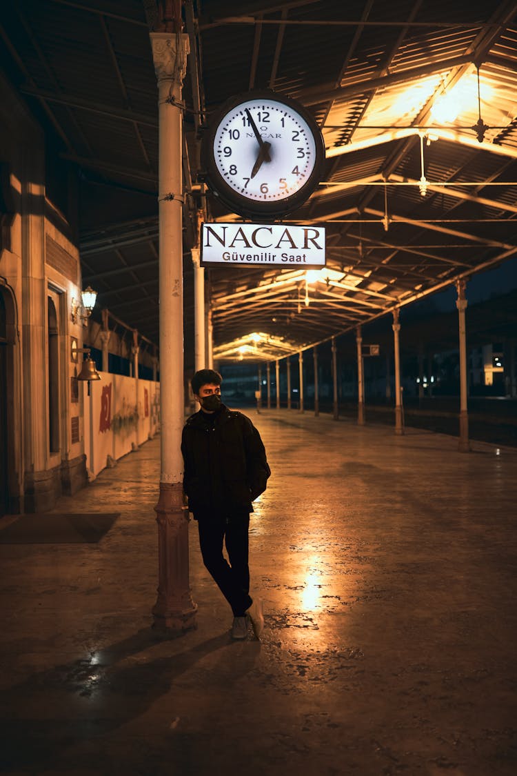 Young Man Waiting At Train Station