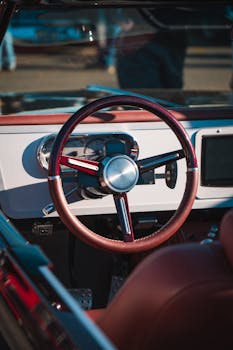 Vintage style car interior showcasing a retro steering wheel and elegant dashboard.