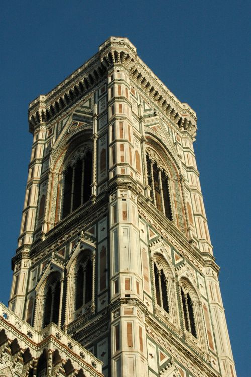Free A stunning low-angle view of Giotto's Bell Tower in Florence, showcasing its intricate Renaissance architecture against a clear blue sky. Stock Photo