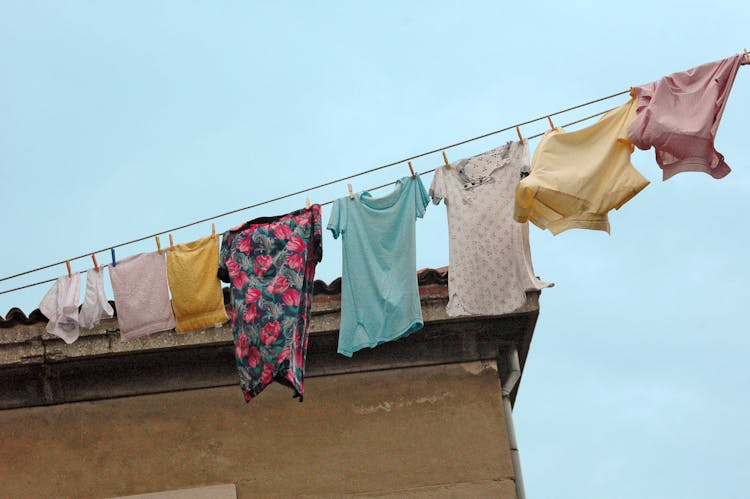 Hanging Clothes On A Wire Under Blue Sky