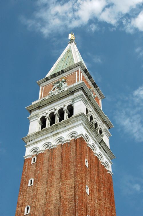Free St Mark's Campanile in Venice under a clear blue sky, showcasing historic architecture. Stock Photo