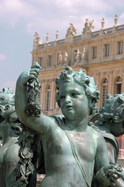 Free Close-up of a cherub statue at the Versailles Palace showcasing elegant details. Stock Photo