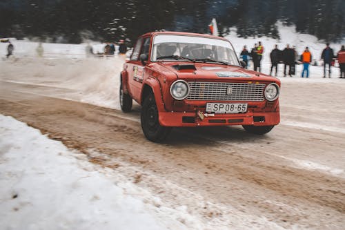 Vintage Car Driving on Dirt Road