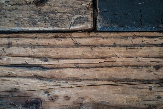 Detailed close-up of weathered, rustic wooden planks showing cracks and texture.
