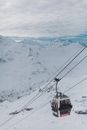 Cable Cars over Snow Covered Mountain