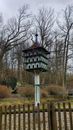 White and Black Wooden Birdhouse on Bare Tree