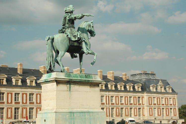 Equestrian Statue Of Louis XIV Under Blue Sky