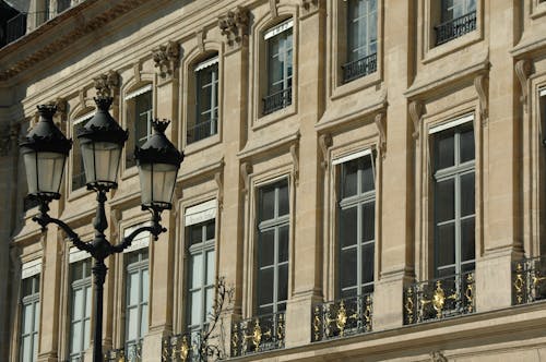A Street Lamps Near the Concrete Building with Glass Windows
