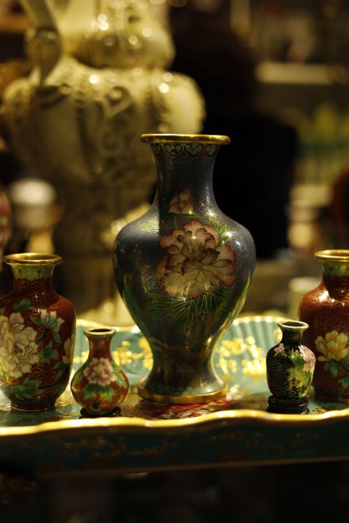 Free Close-up of intricately designed ornamental vases with floral patterns in warm lighting. Stock Photo