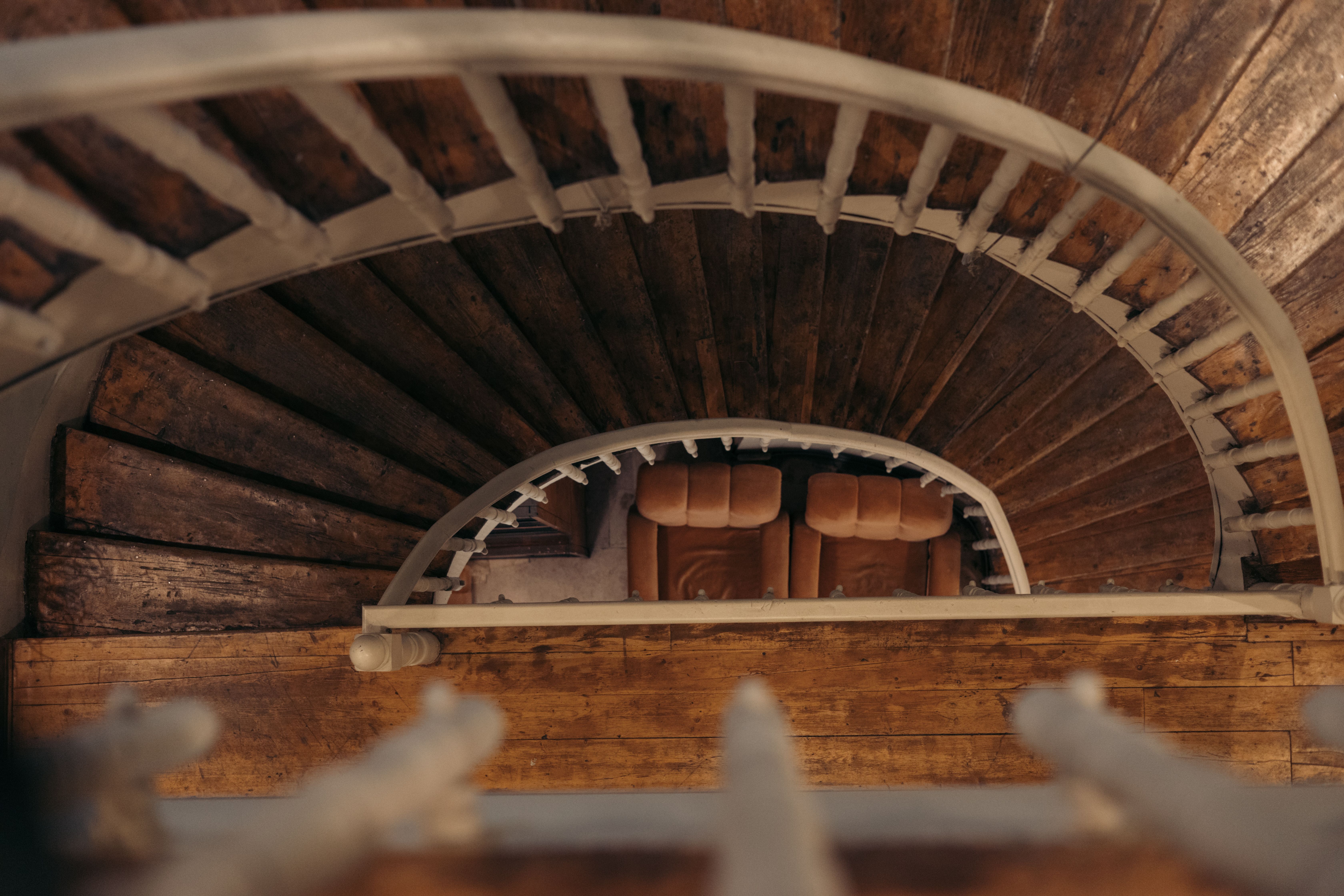 A narrow, winding staircase in a home. - i need to move a piano