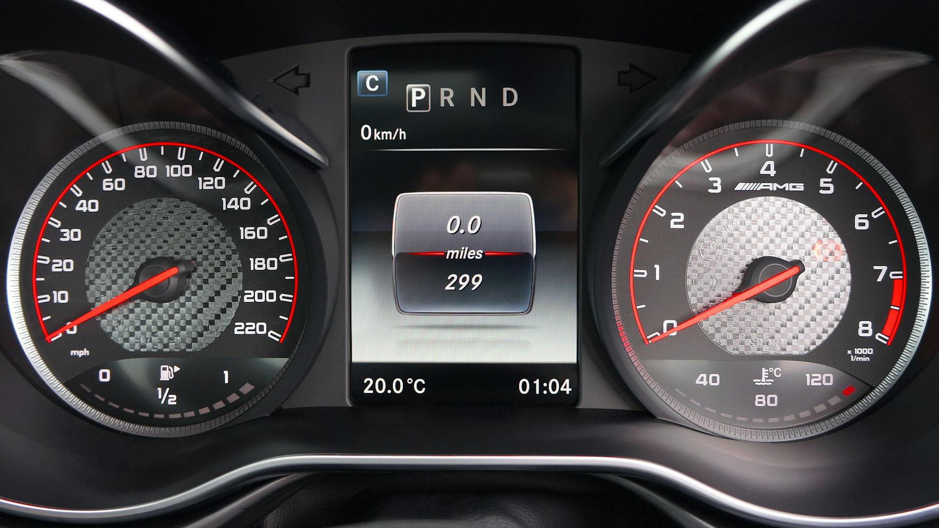 Close-up image of a modern car dashboard featuring digital displays and speedometer.