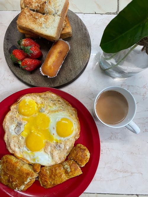 Free Tasty breakfast with sunny side up eggs, toast, strawberries, and coffee, shot from above. Stock Photo