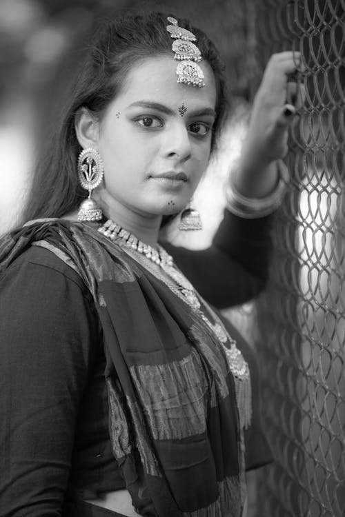 A Woman Holding a Chain Link Fence