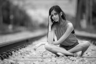 Woman in Black Tank Top Sitting on the Ground
