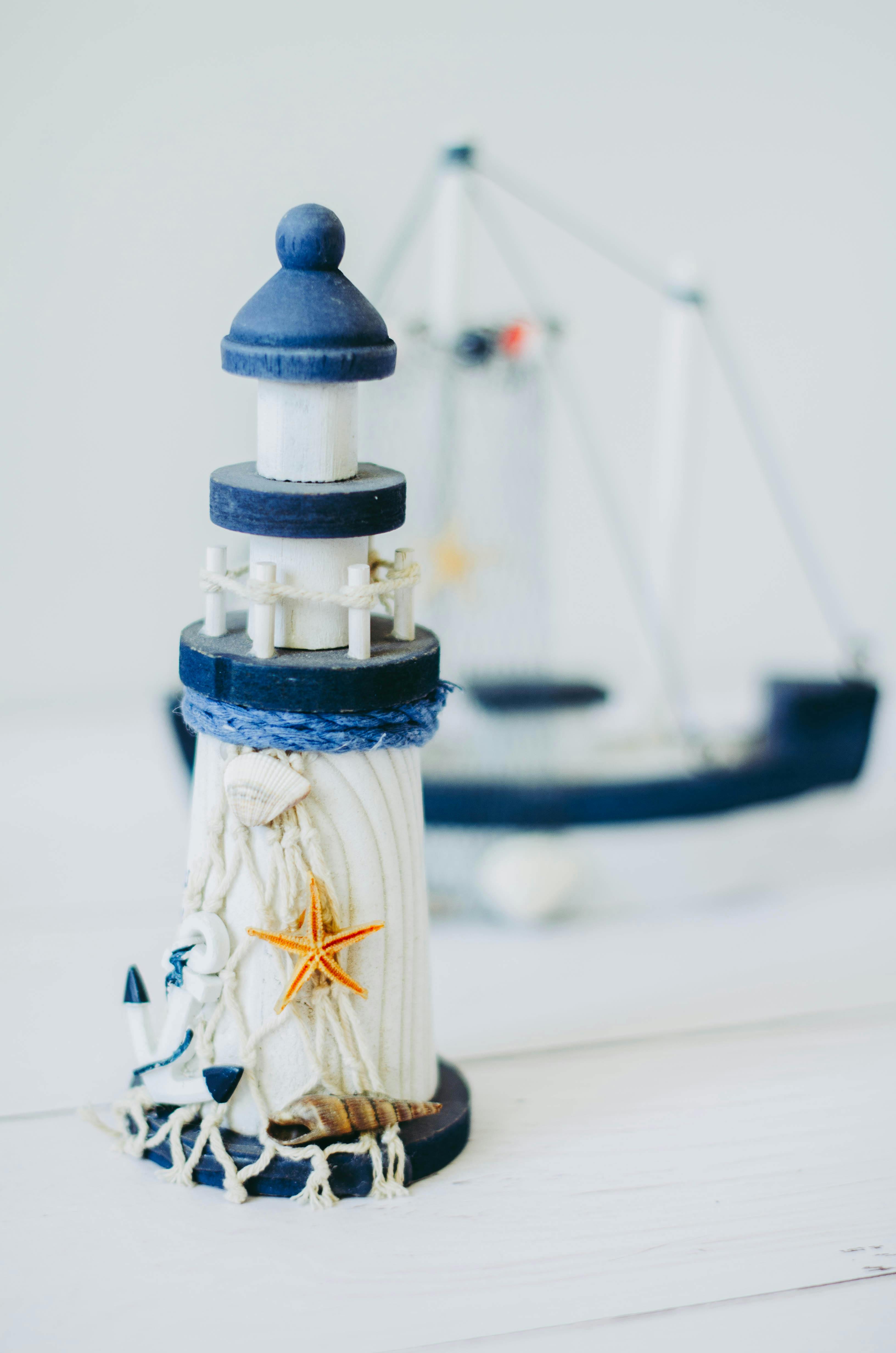 A detailed miniature lighthouse with nautical elements, perfect for decor.