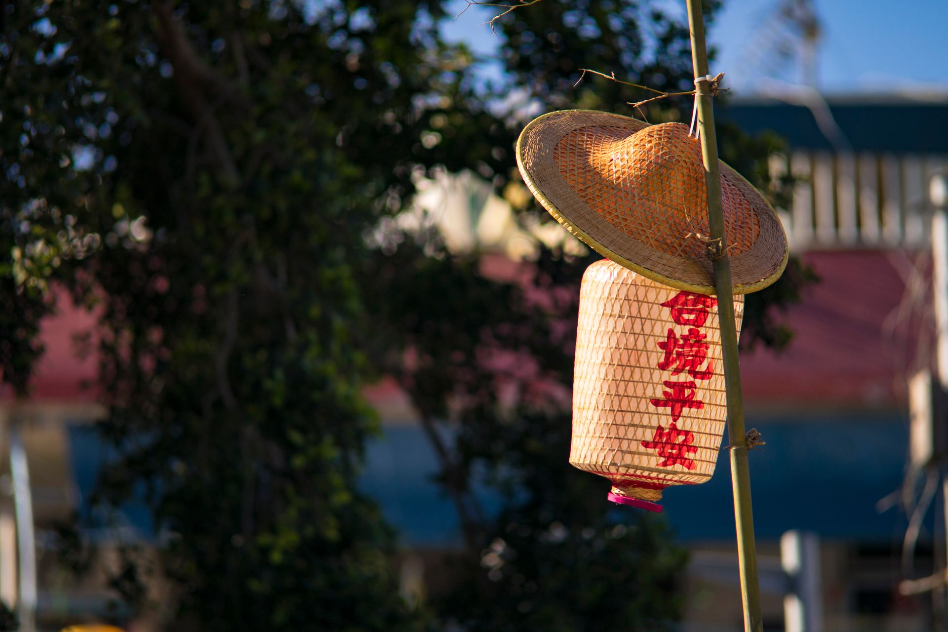 Straw Hat And Paper Lantern Placed On Bamboo Pole
