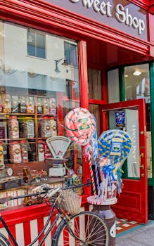 Colorful sweet shop in Killarney with candies, bicycle, and vibrant storefront.