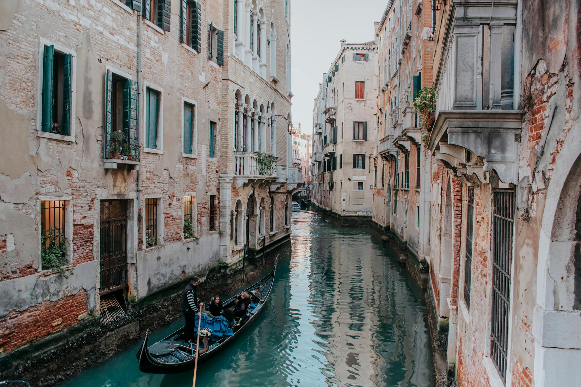Discover the allure of Venice's waterways with this picturesque canal scene featuring a traditional gondola and classic architecture.