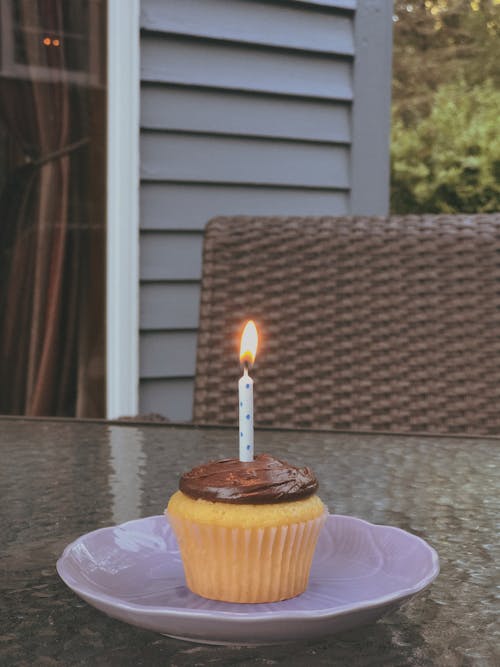A Cupcake With a Lit Candle 