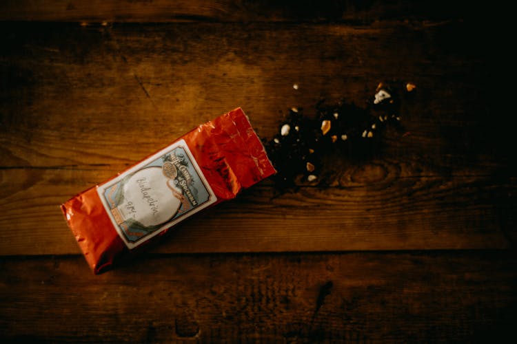 Opened Packaging On A Wooden Table Top 