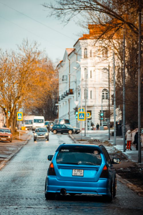 Free Scenic view of a city street in Kaliningrad with cars and historical buildings on a late winter day. Stock Photo