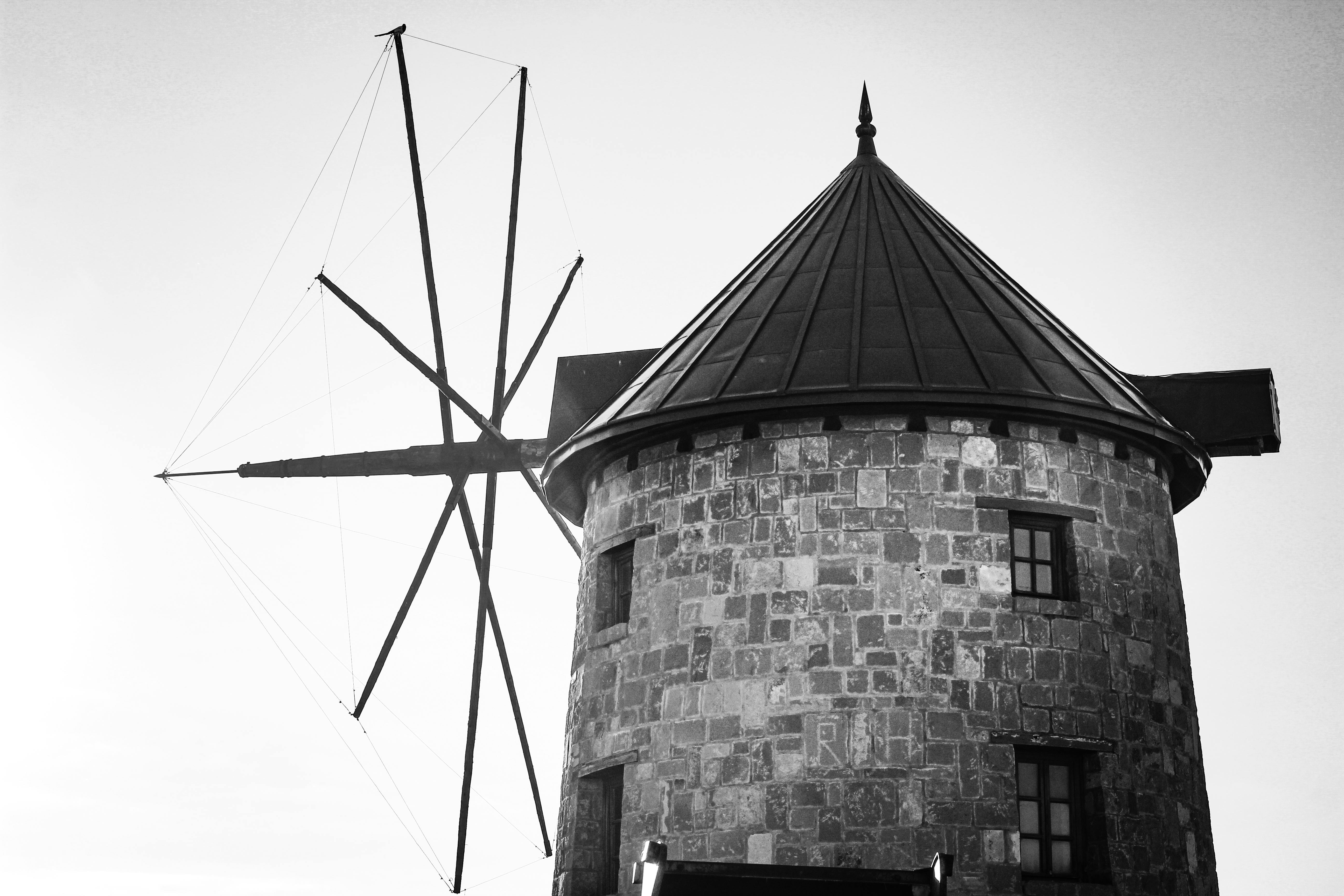 Monochrome image of a traditional stone windmill in Türkiye, showcasing architectural elegance.