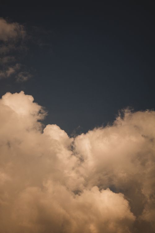 Free A tranquil image of clouds against a darkening sky, capturing the serene beauty of nature. Stock Photo