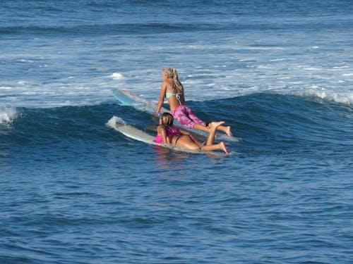 Women Surfboarding on Sea