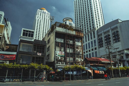 Street view of contrasting old and new architecture in Bangkok, Thailand.