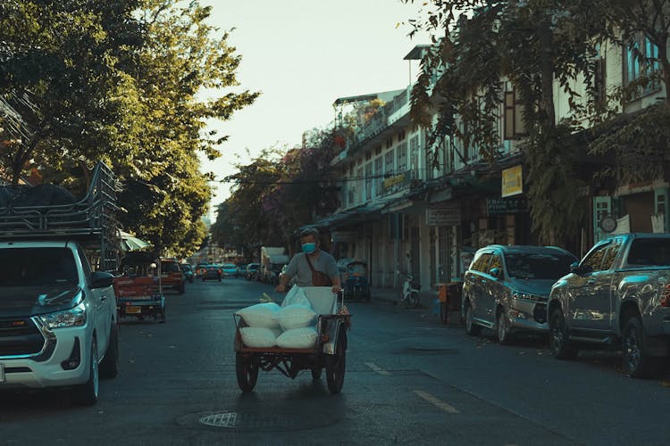 A Man Pushing A Cart