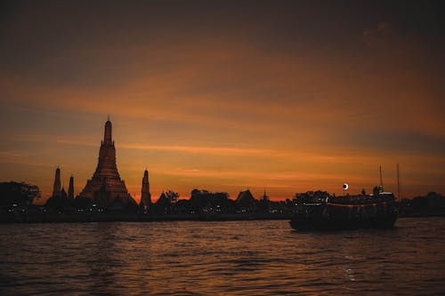 The Wat Arun by the Chao Phraya River During Sunset