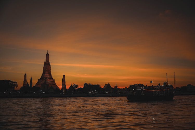 The Wat Arun By The Chao Phraya River During Sunset