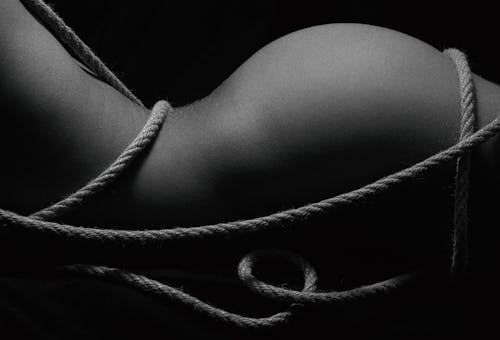 A Naked Person with Rope Around its Body