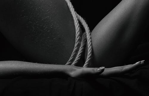 Free Black and White Photo of a Person's Hand Near a Rope Stock Photo