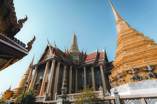 Beautiful capture of Grand Palace temple's intricate architecture and golden pagoda in Bangkok, Thailand.