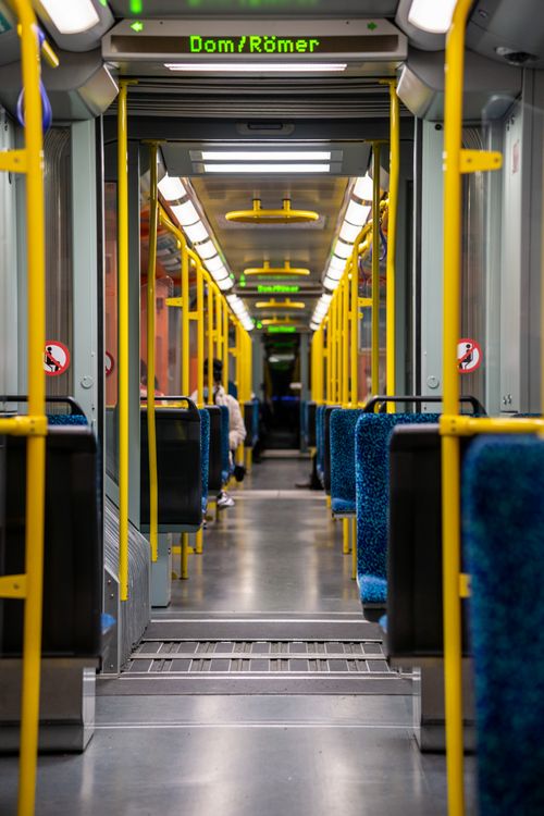 Free View inside a modern subway car in Frankfurt, Germany featuring blue seats and yellow railings. Stock Photo