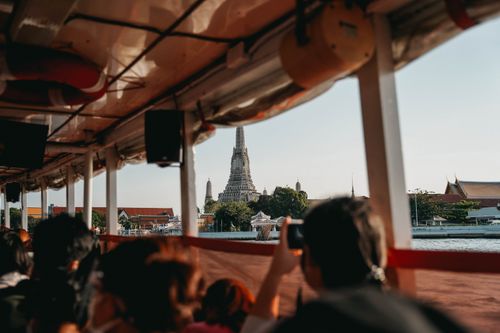 Free A scenic view of Wat Arun temple from a riverboat in Bangkok, capturing the essence of Thai culture. Stock Photo