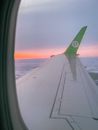 White Airplane Wing over the Sea during Sunset