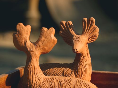 Free Close-up view of intricately carved clay deer sculptures with detailed texture. Stock Photo