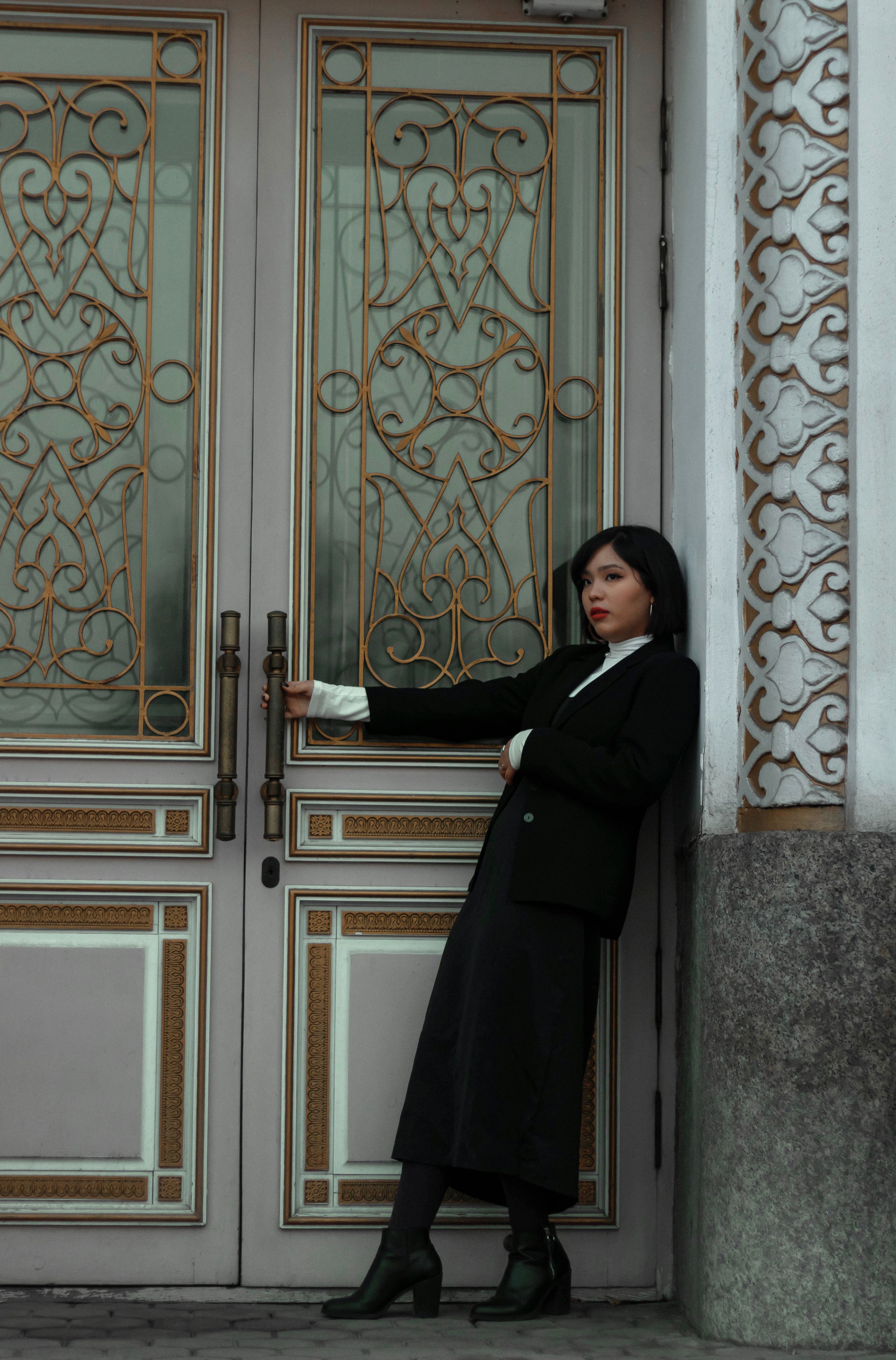A Stylish Woman Posing by the Doorway · Free Stock Photo