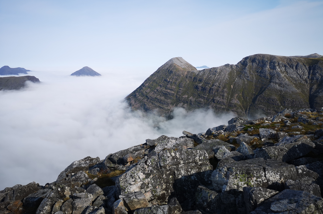 Gray Rocky Mountain Over White Clouds · Free Stock Photo