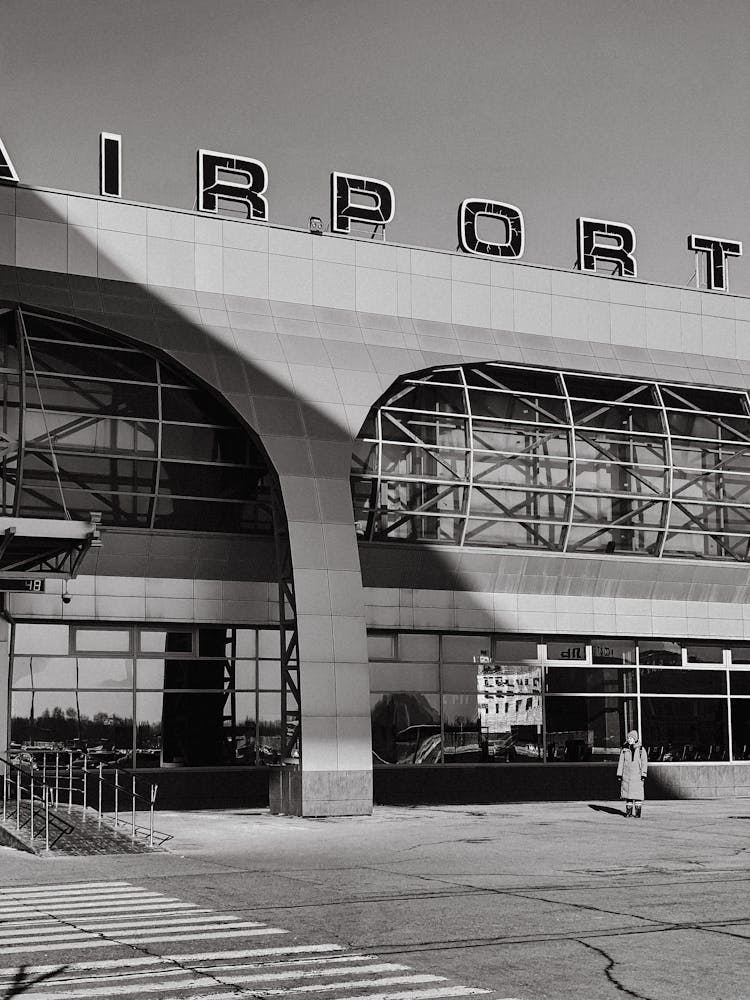 A Person Standing Outside An Airport