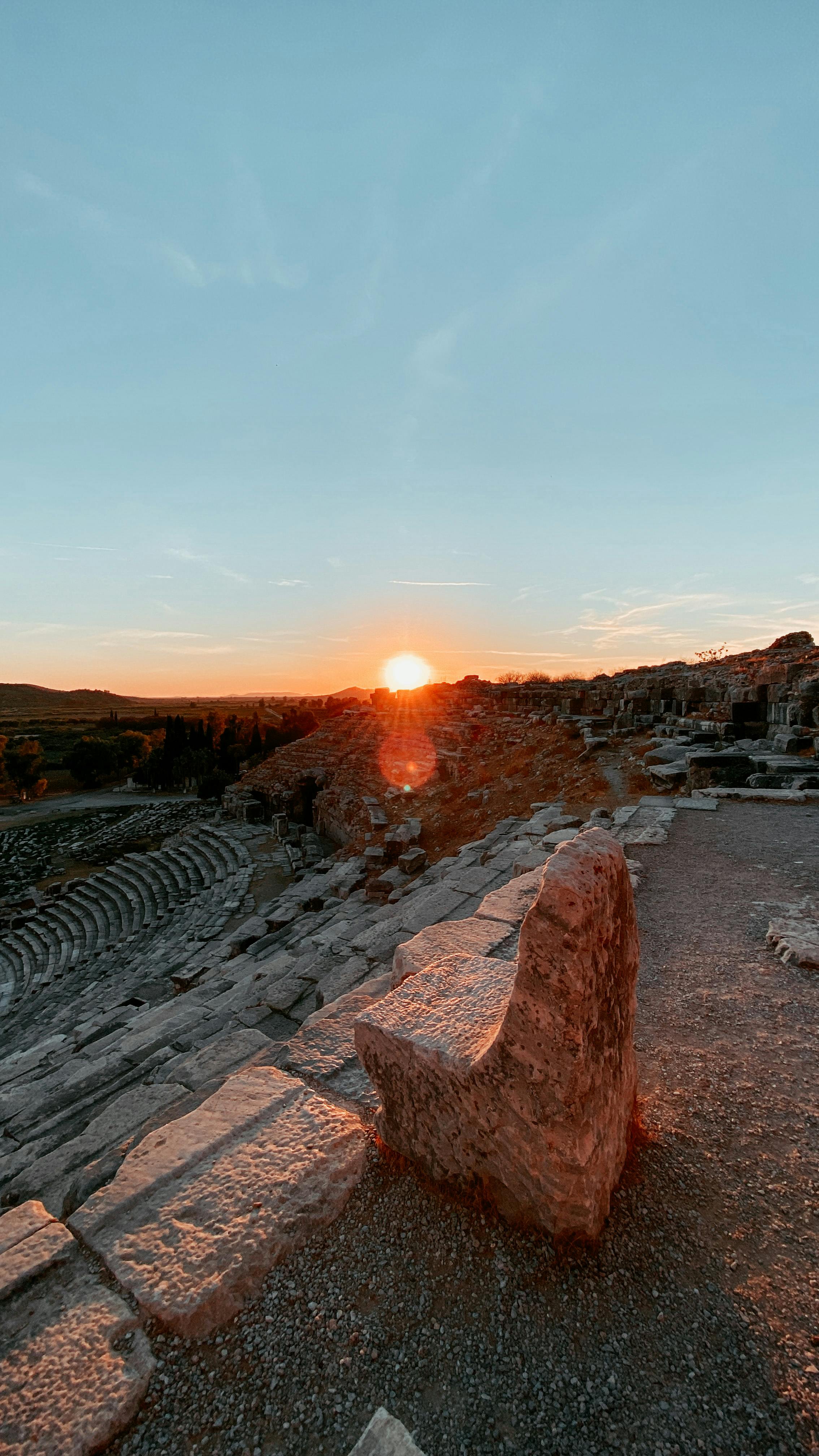 Free Captivating view of an ancient amphitheater with a stunning sunset backdrop. Stock Photo